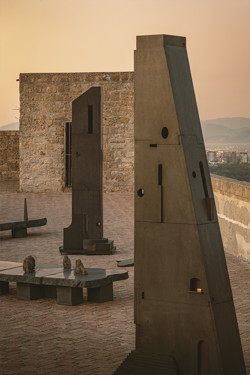 totemic sculptures compose volcanic stone landscape for site-specific installation in naples