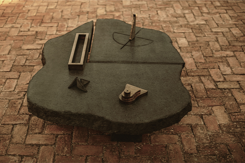 totemic sculptures compose volcanic stone landscape for site-specific installation in naples