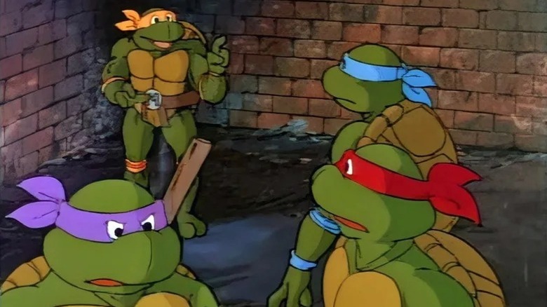 Cam Clarke's Leonardo, Barry Gordon's Donatello, Rob Paulsen's Raphael, and Townsend Coleman's Michelangelo hanging in the sewer in Teenage Mutant Ninja Turtles
