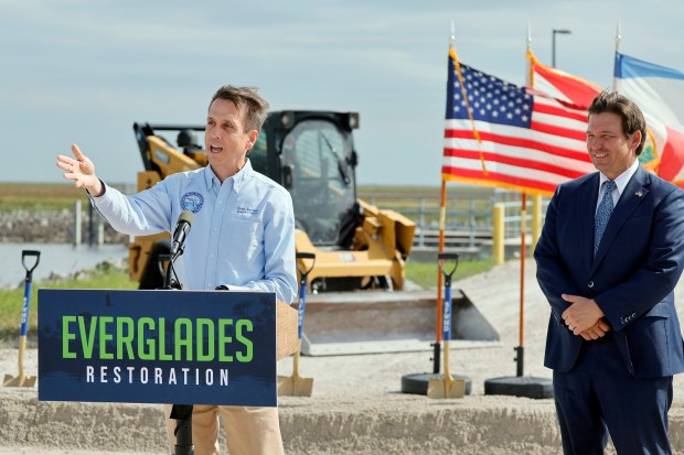 Florida Gov. Ron DeSantis looks on as South Florida Water Management District Executive Director Drew Bartlett speaks during a news conference in South Bay, Fla., on Thursday, Nov. 6, 2025. (Amy Beth Bennett / South Florida Sun Sentinel)