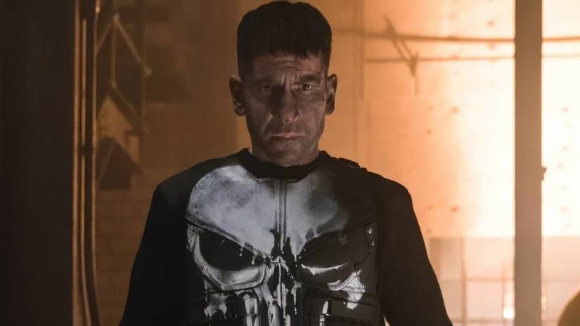 The Punisher standing in a warehouse.