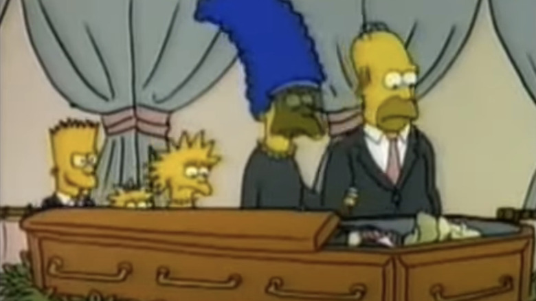 The Simpsons family stand over the coffin of Hubert Simpson in The Simpsons short The Funeral
