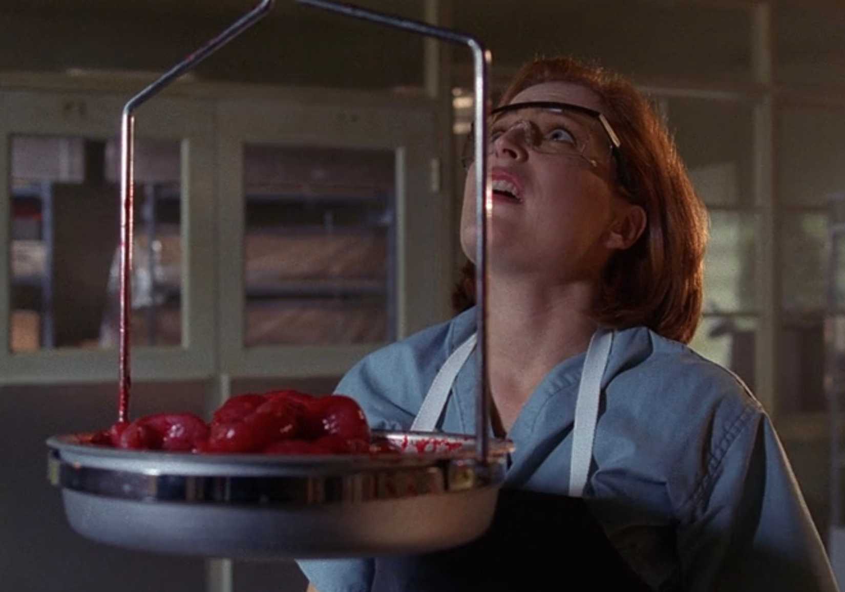 Dana Scully (Gillian Anderson) weighs a pile of organs in The X-Files episode "Bad Blood"