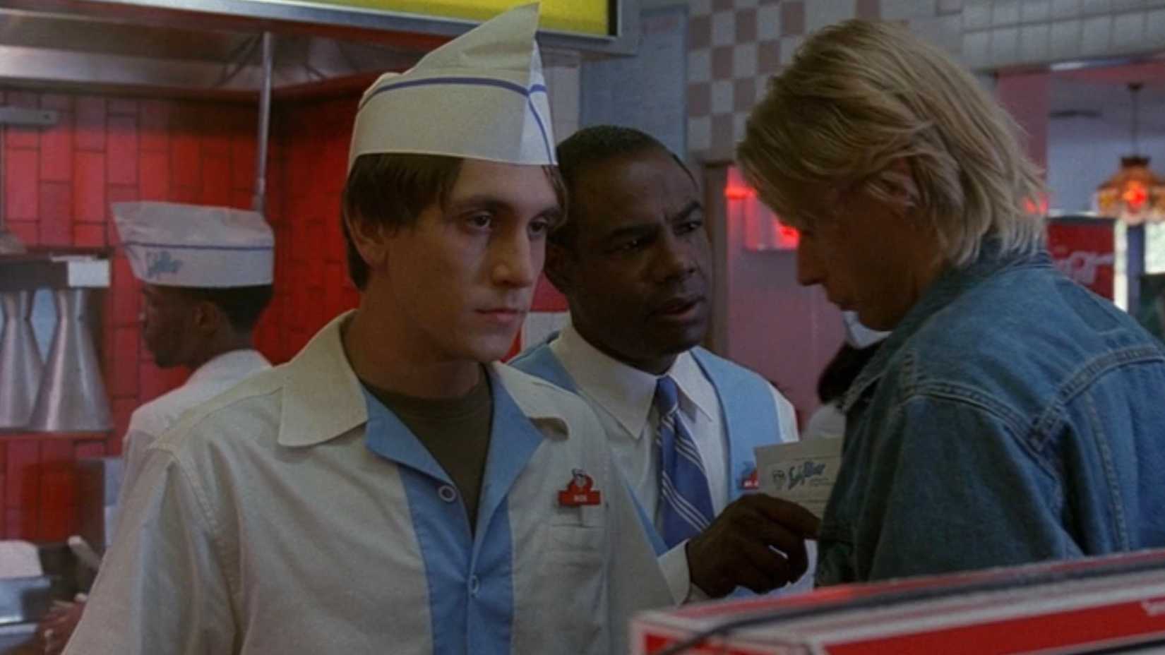 A fast-food worker (Chad Donella) looks upset while his coworkers argue in The X-Files episode "Hungry"