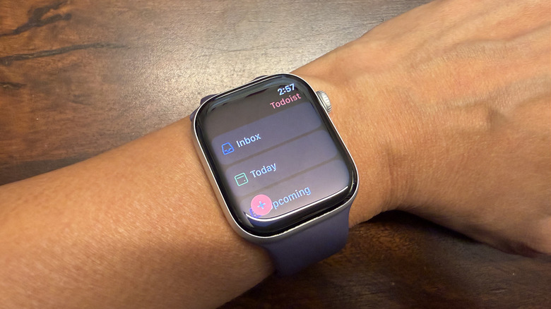 A wrist with an Apple Watch showing the Todoist app.