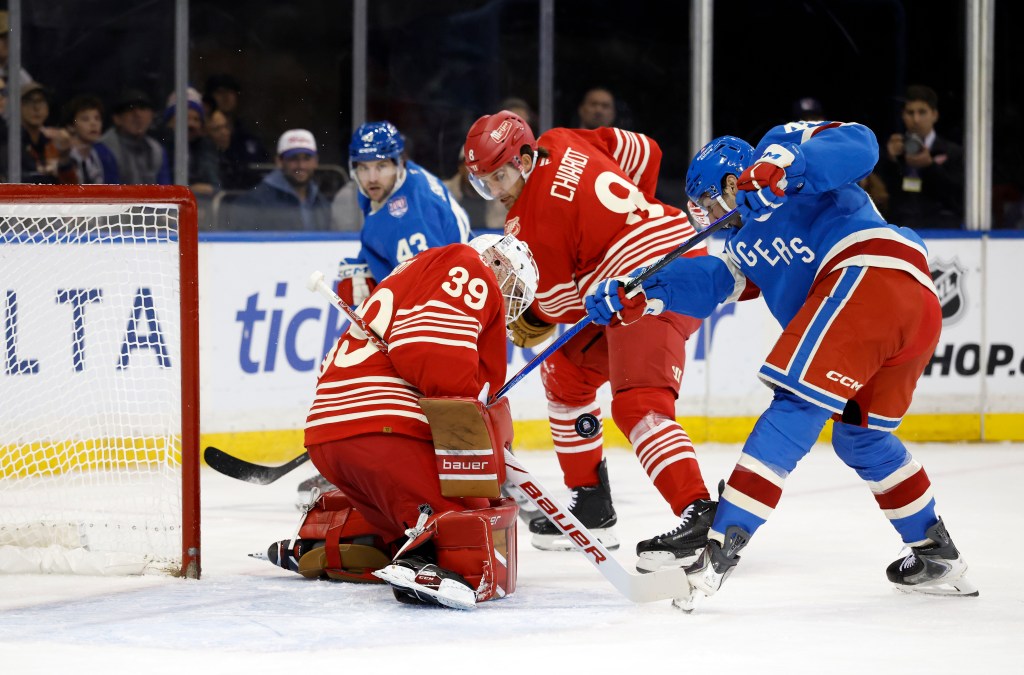 New York Rangers center Noah Laba shoots the puck past Detroit Red Wings goaltender Cam Talbot.