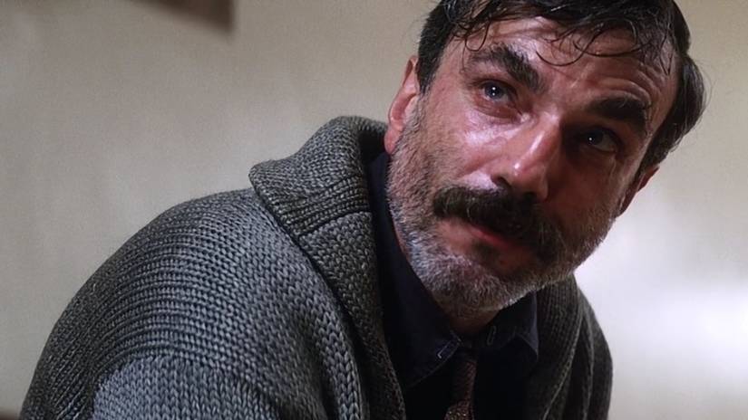 Daniel Plainview looks angrily up at Eli in There Will Be Blood
