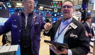 Wall Street slips as more companies report their results