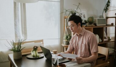 Investor reviewing documents on laptop.