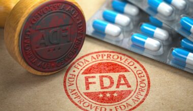 A rubber stamp that says FDA Approved next to some packages of pills.