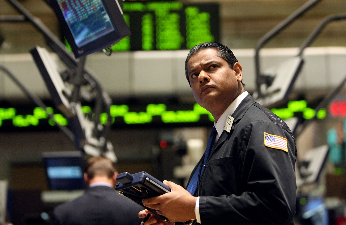 A New York Stock Exchange floor trader who's looking up in bewilderment at a computer monitor.