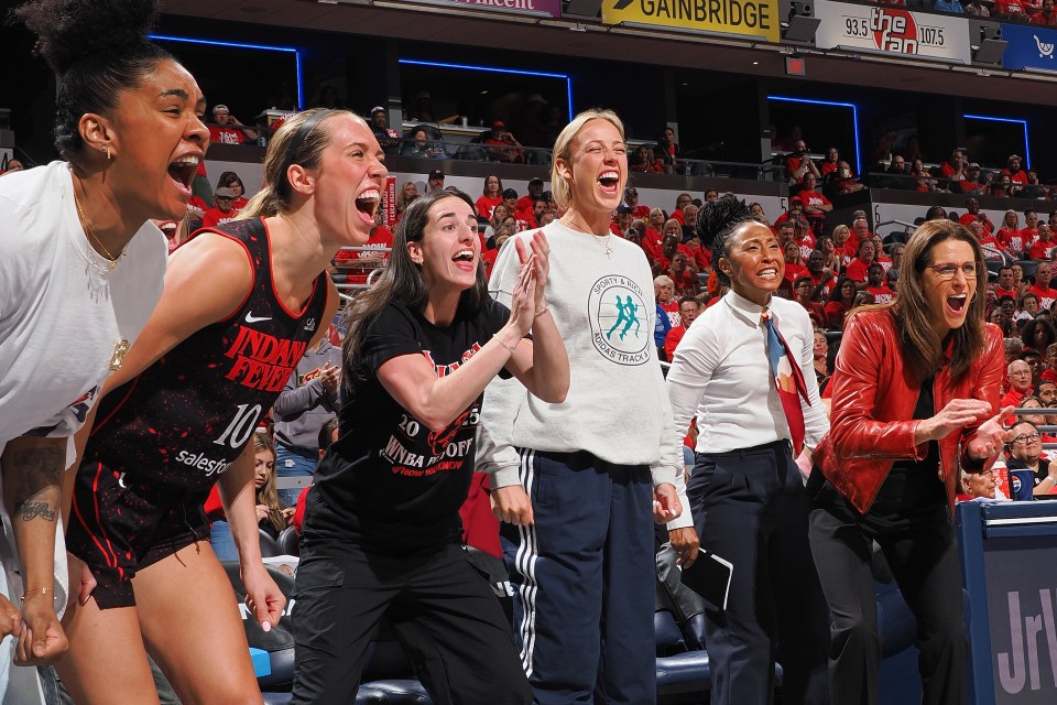 Damiris Dantas #12, Lexie Hull #10, Caitlin Clark #22, Sophie Cunningham #8 and Head Coach Stephanie White of the Indiana Fever celebrates during the game against the Atlanta Dream during round 1 game 2 on September 16, 2025