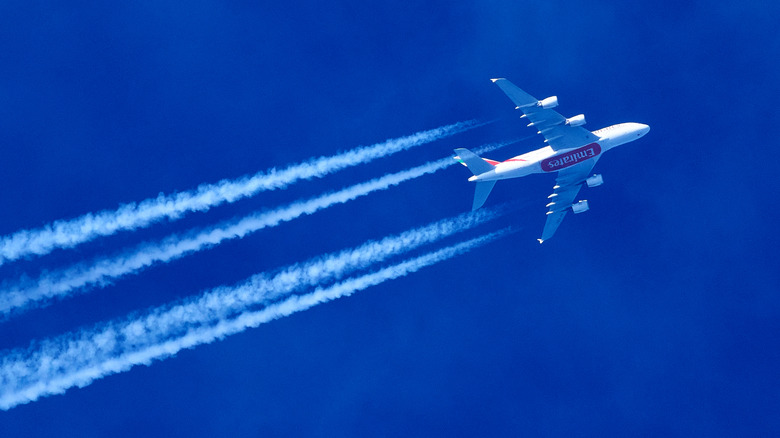 Emirates Airbus flight with contrails