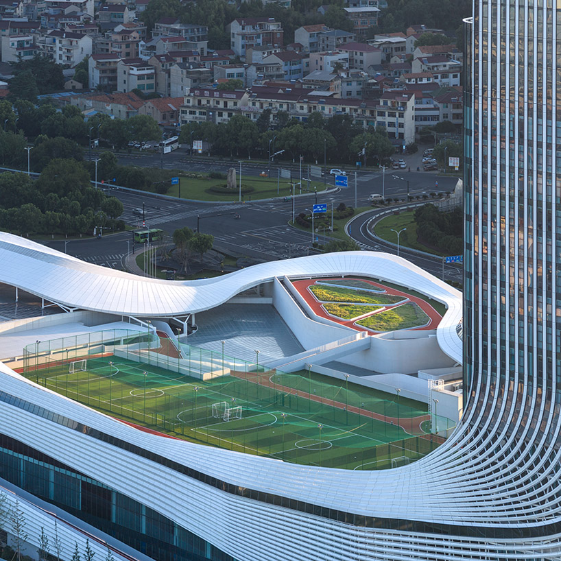 line+ wraps mixed-use sports mall's undulating facade in perforated aluminum panels