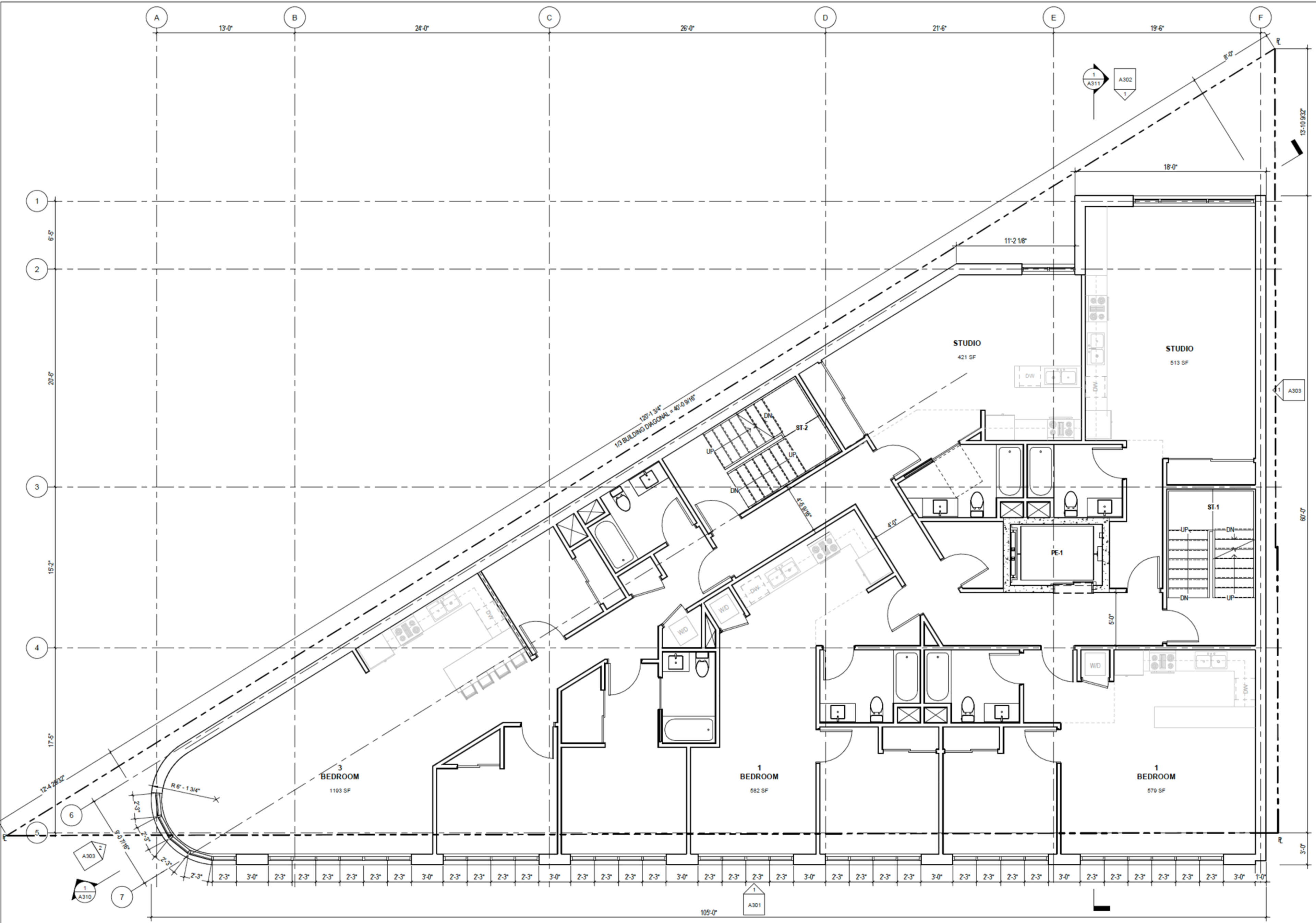 A floor plan of an irregularly shaped building shows three bedrooms, two studios, multiple bathrooms, kitchens, stairwells, and hallways.