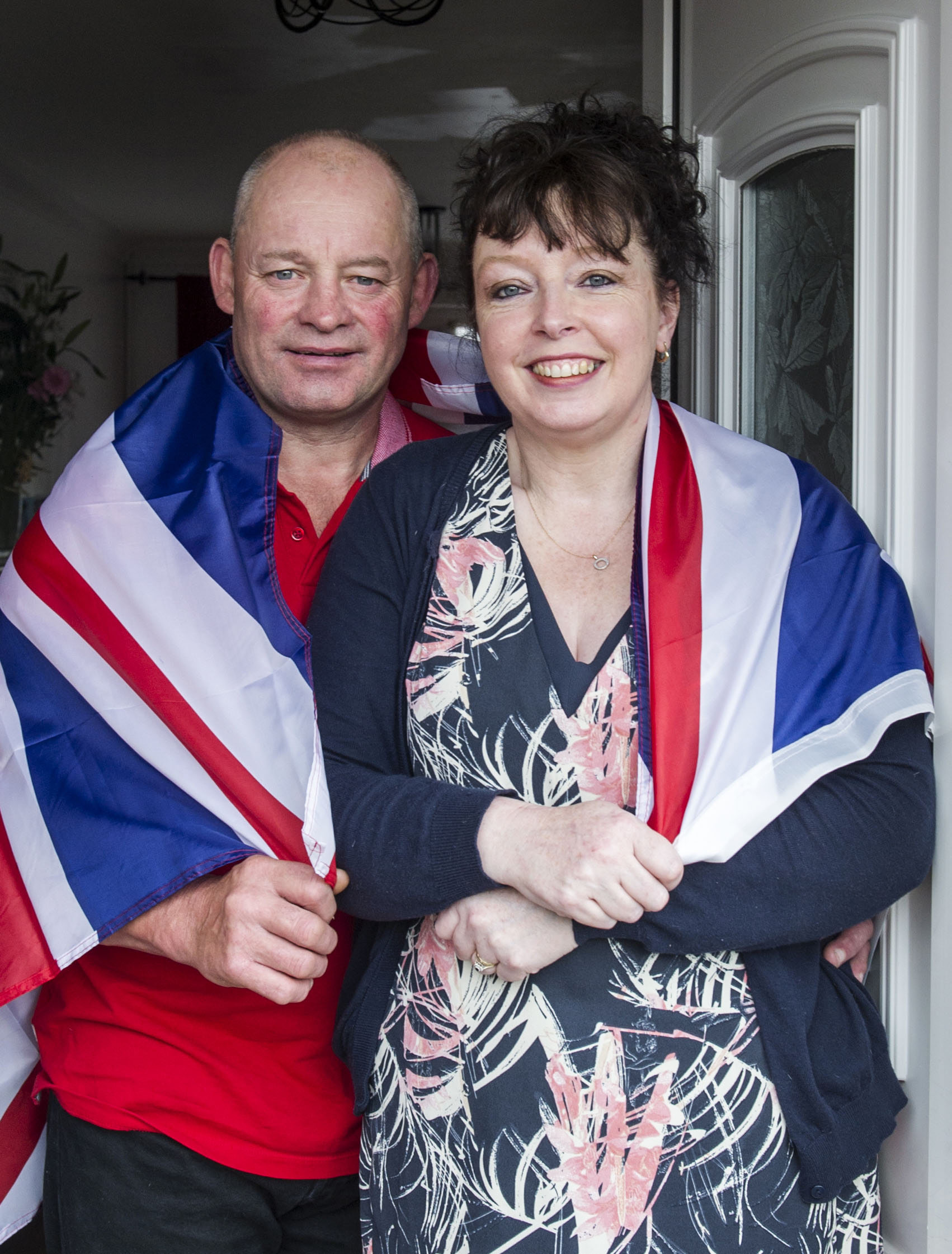 Caroline and Mark Peaty wrapped in a Union Jack flag.