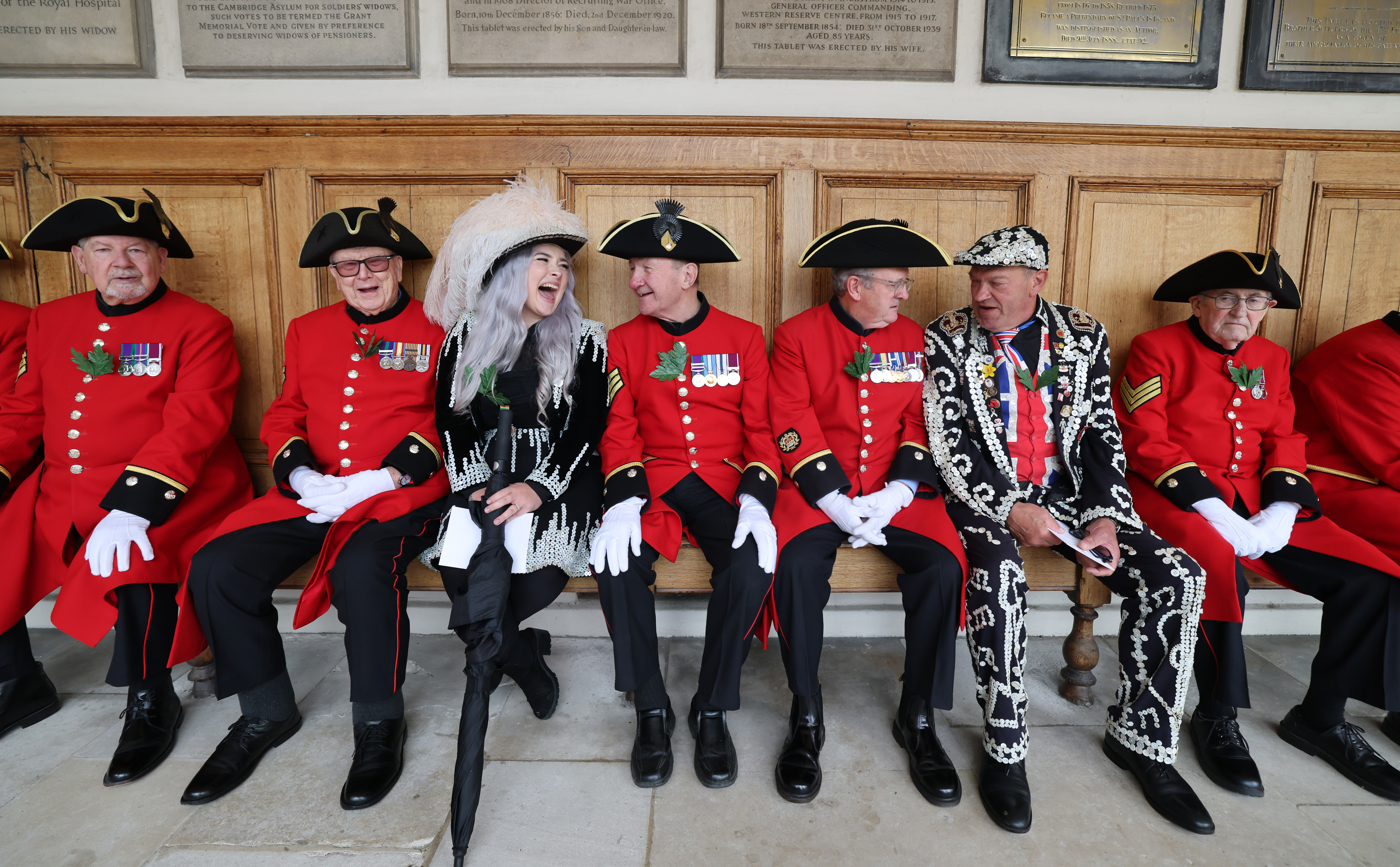 Pearly Kings and Queens sitting with Chelsea Pensioners at the Royal Hospital in Chelsea.