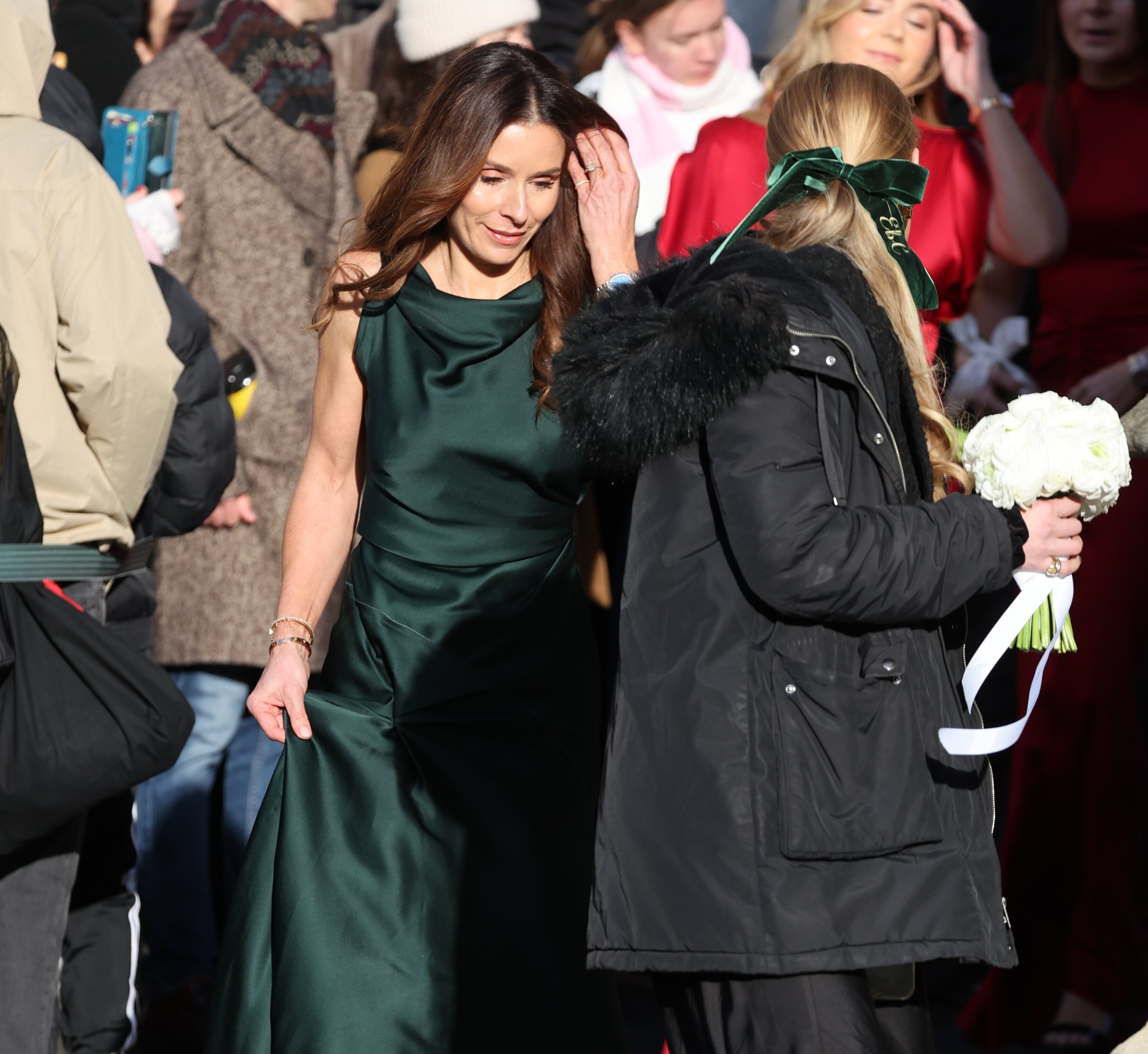 Woman in a green gown arriving at the wedding of Adam Peaty and Holly Ramsay.