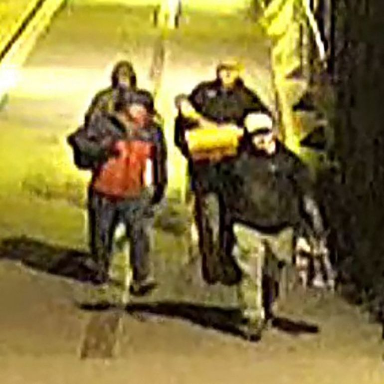 This handout image of CCTV footage released by Avon and Somerset Police on December 11, 2025 shows men carrying bags in the early hours of September 25 in the city of Bristol. [Avon and Somerset Police/AFP]