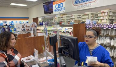 Customer Lisa Durs is helped by pharmacy clerk Kira Tomoney at Minnich