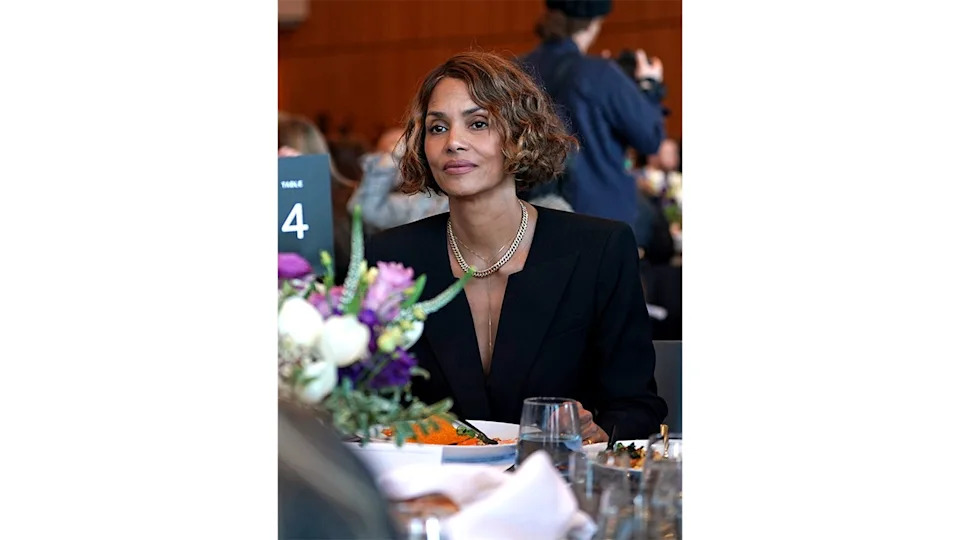 Halle Berry sits at a table during the DealBook Summit