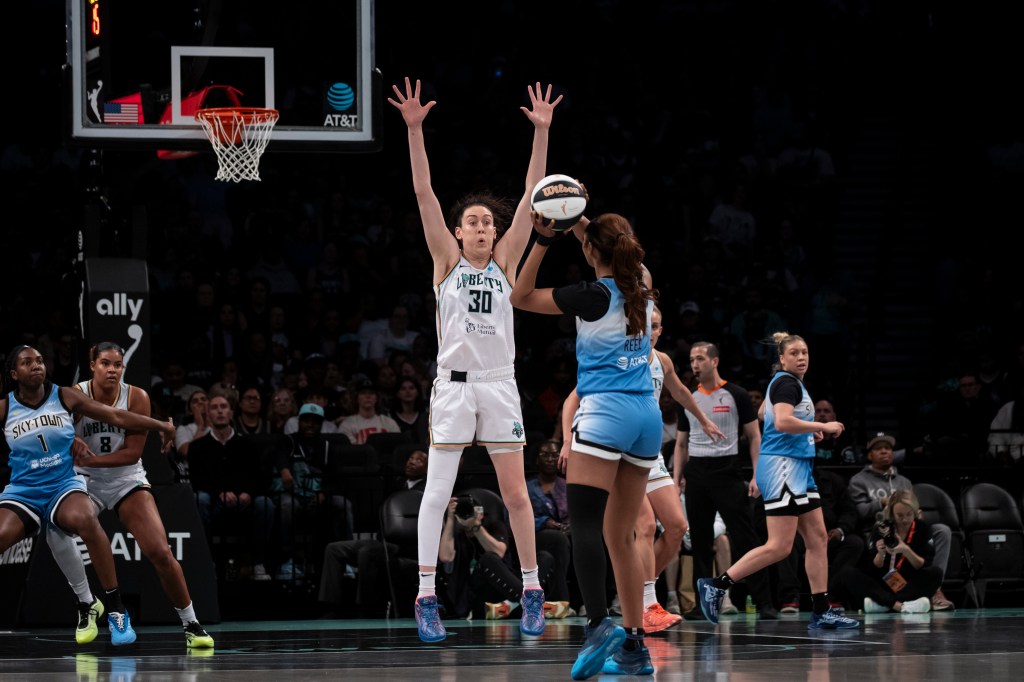 Breanna Stewart #30 of the New York Liberty blocks a shot against Angel Reese #5 of the Chicago Sky.