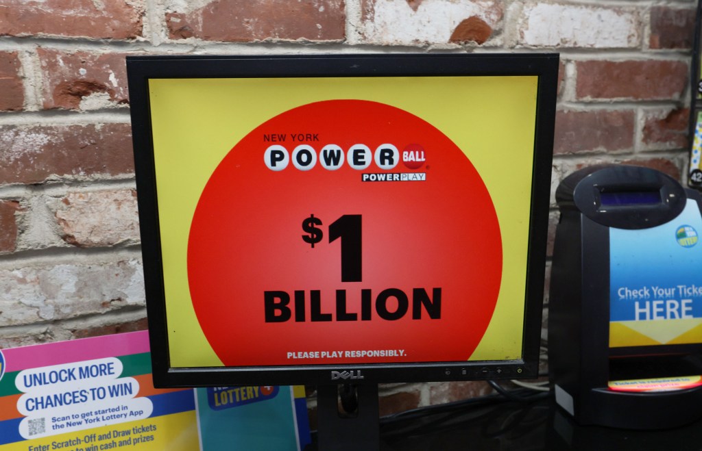 A Powerball lottery screen displaying "$1 BILLION" on a red circle against a yellow background.