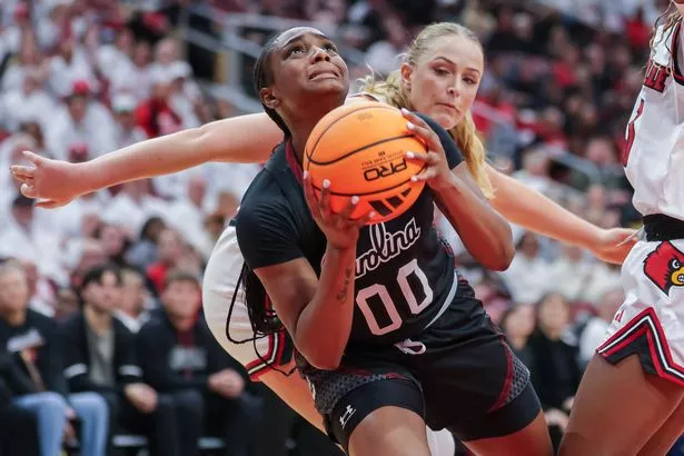 Ta'Niya Latson #00 of the South Carolina Gamecocks looks up to shoot against Laura Ziegler #0 of the Louisville Cardinals during the second half at KFC YUM! Center on December 4, 2025 in Louisville, Kentucky