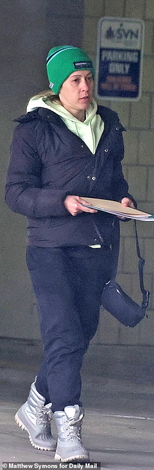 Kelli, who was seen clutching documents, got behind the wheel of Moore’s black Chevy Tahoe