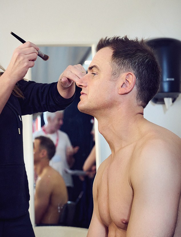 Guy is prepared for his cover shoot - 24 hours earlier he had been packed off for a spray tan, which involved standing in a tent, while his body was covered in chocolate-coloured paint