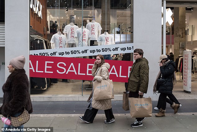 Shoppers walk along Oxford Street during Boxing Day sales in London on December 26, 2025