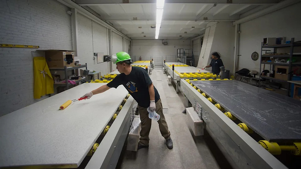 workers manufacturing white countertops