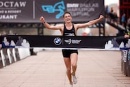 BMW Dallas Marathon mens winner Travis Dowd reacts as he approaches the finish line tape...