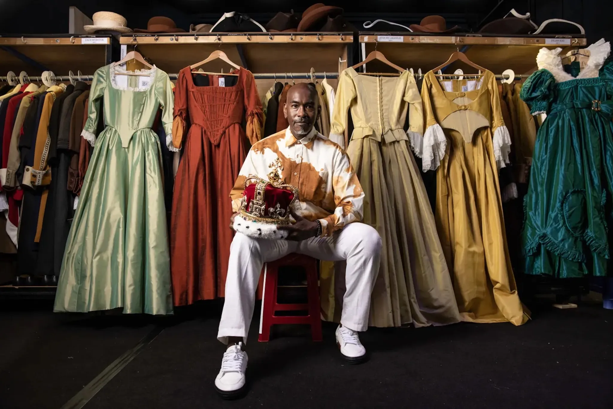 Paul Tazewell poses in front of costumes he designed.