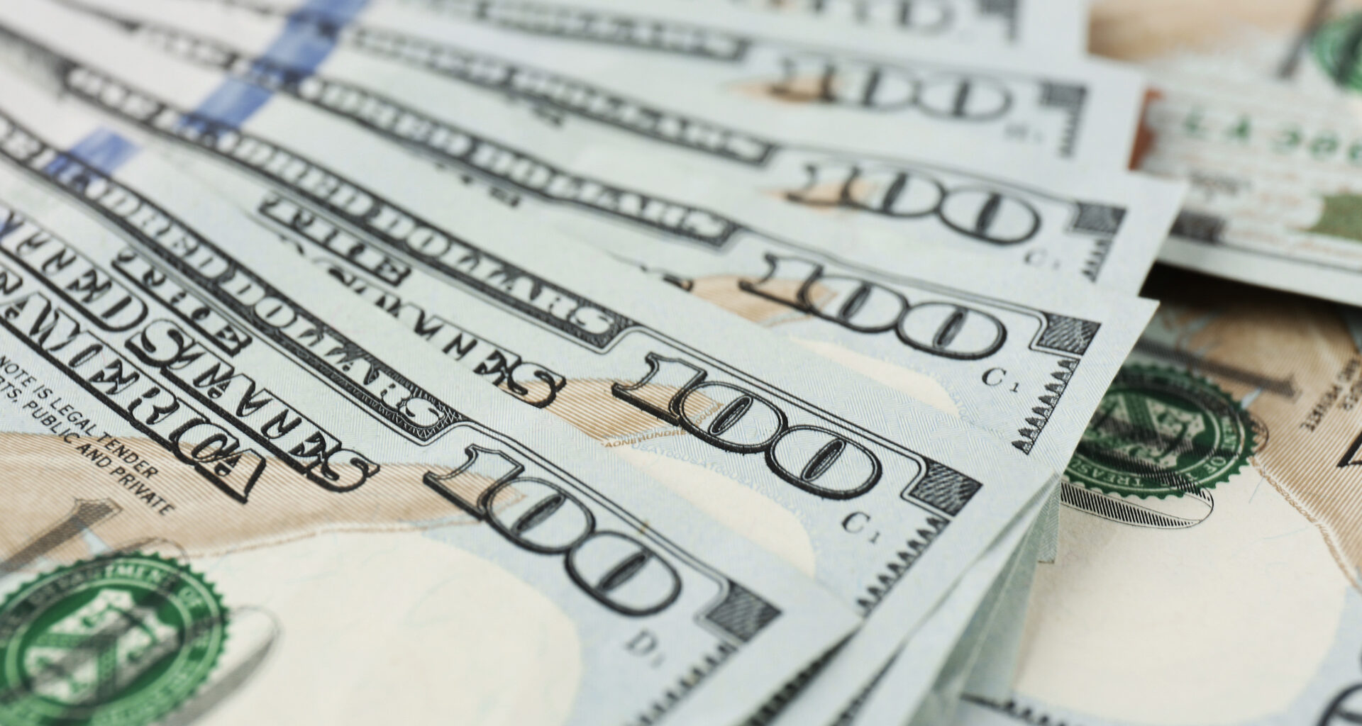 Fan shaped hundred dollars cash money as background.