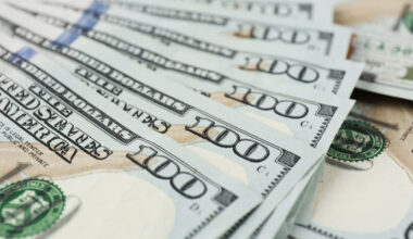 Fan shaped hundred dollars cash money as background.