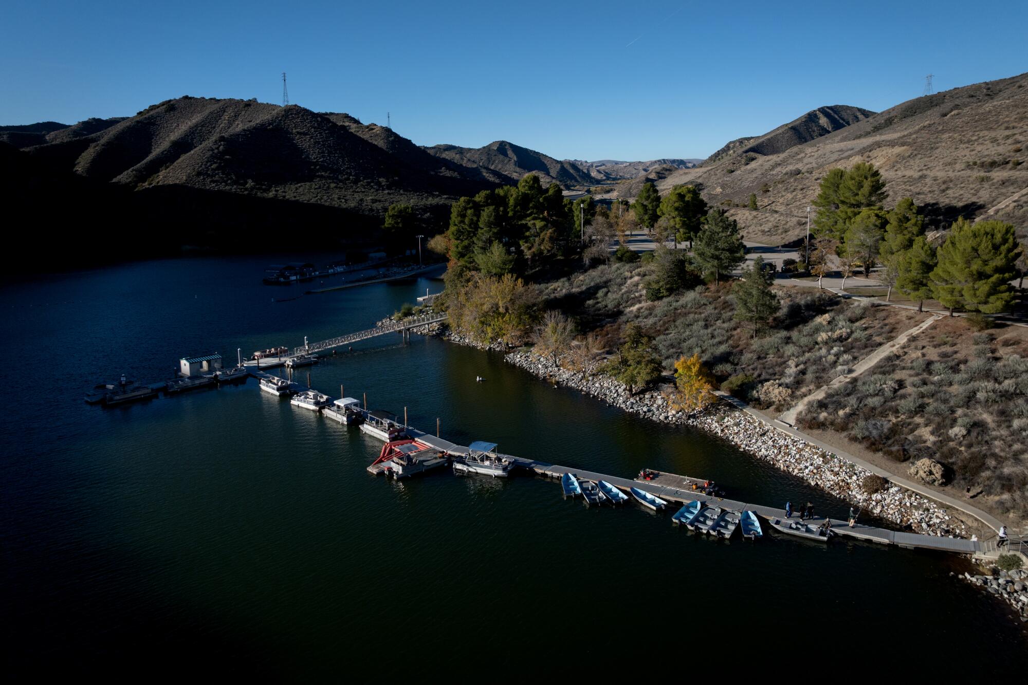 A deep blue lake with mountains nearby.