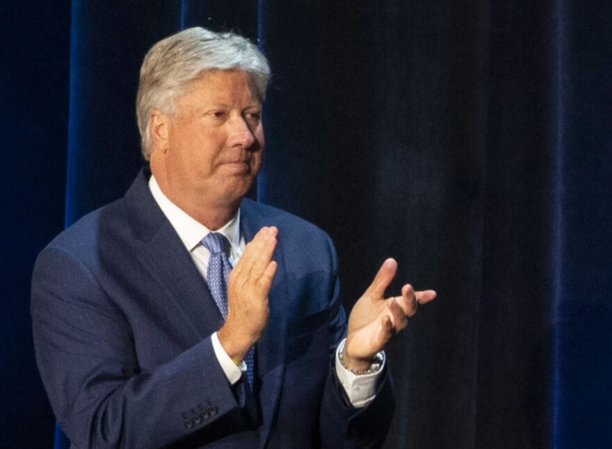 A man in a suit clapping
