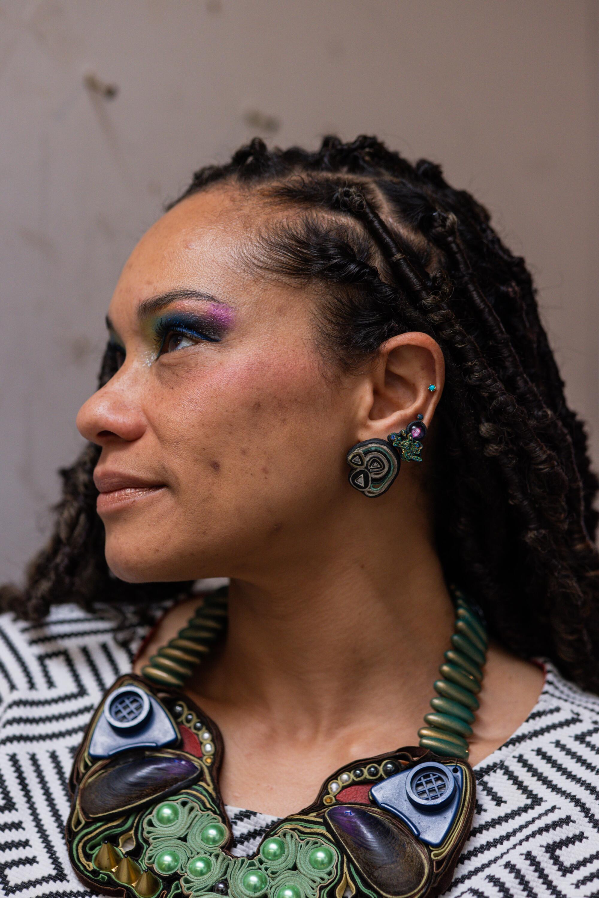 Alicia Piller wears a large multimedia necklace.