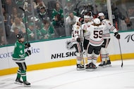 Dallas Stars defenseman Miro Heiskanen (4) skates by as Chicago Blackhawks center Jason...