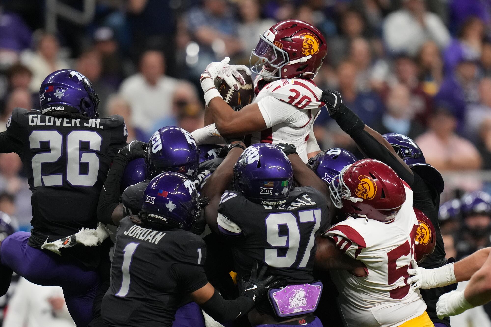 USC running back King Miller is stopped short by the Texas Christian defense.