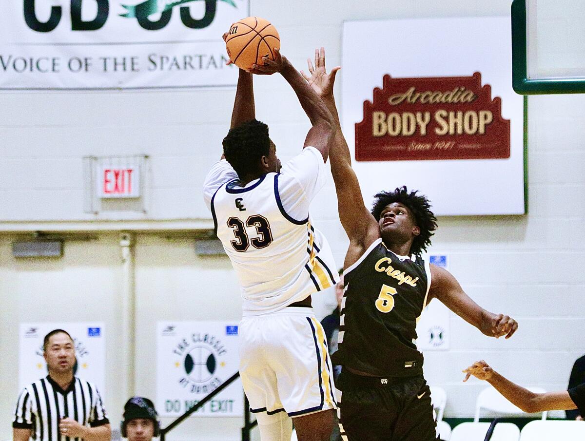 Crespi’s Rodney Mukendi tries to block a jump shot by Crean Lutheran’s Chadrack Mpoyi.
