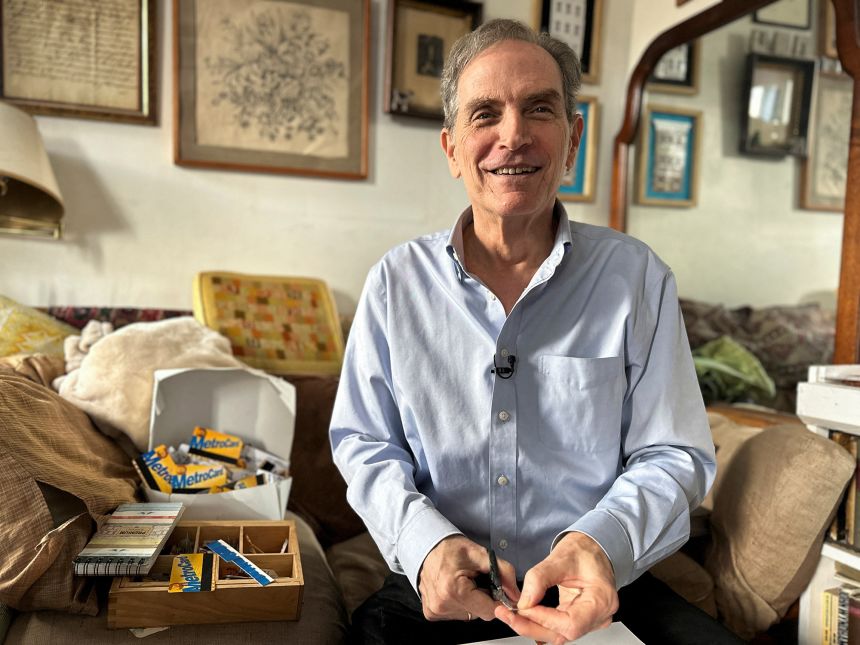 New York City artist Thomas McKean, who creates sculptures and mosaics with MetroCards, cuts a MetroCard on January 27, 2023.