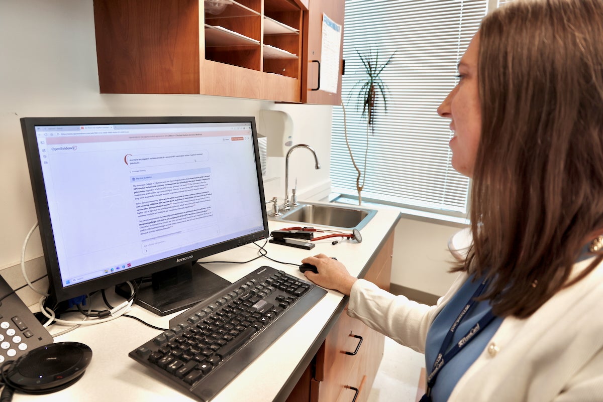 Corinne Rhodes looks at a computer