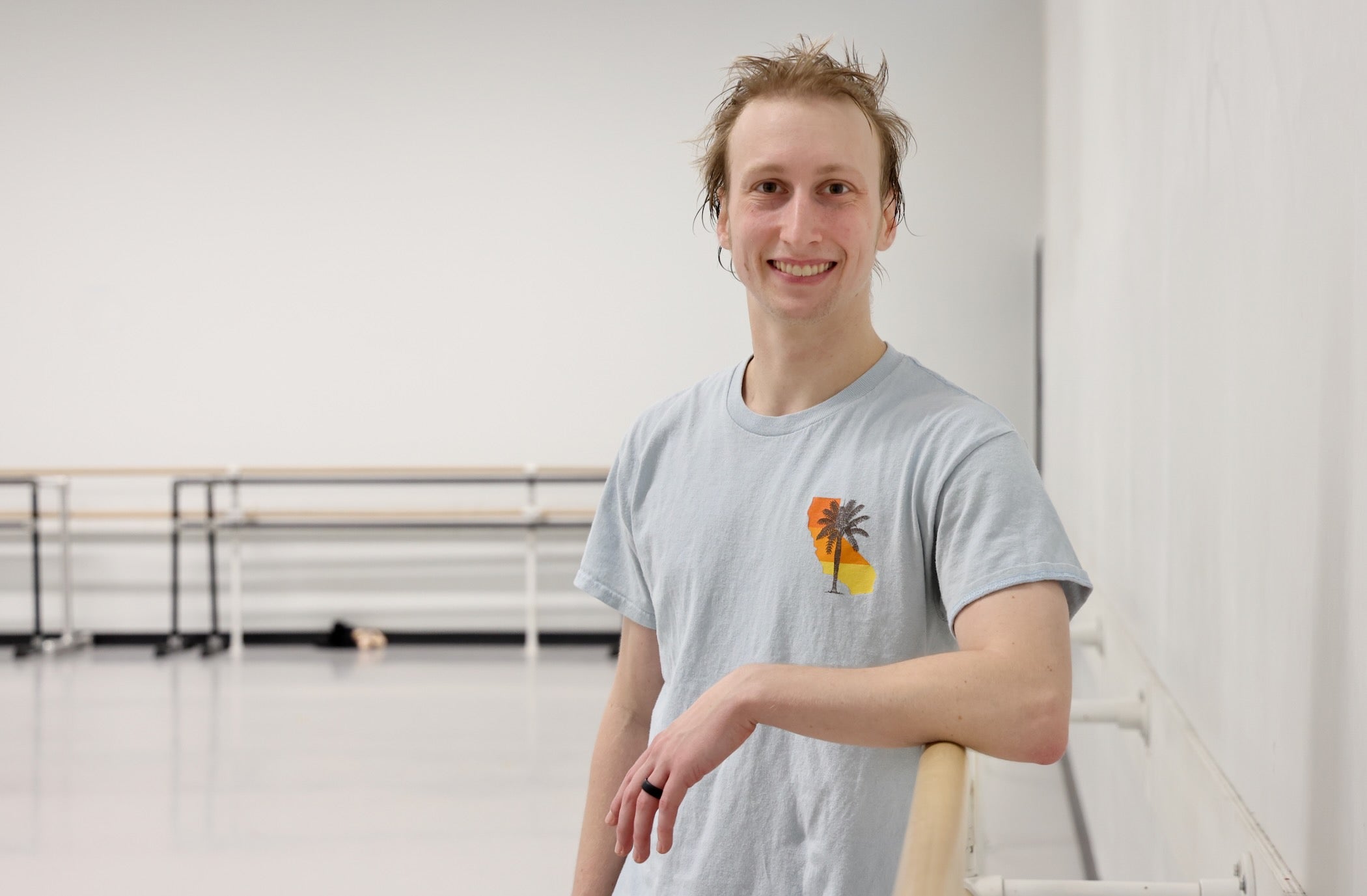 Nicholas Patterson posing for a photo in the dance studio