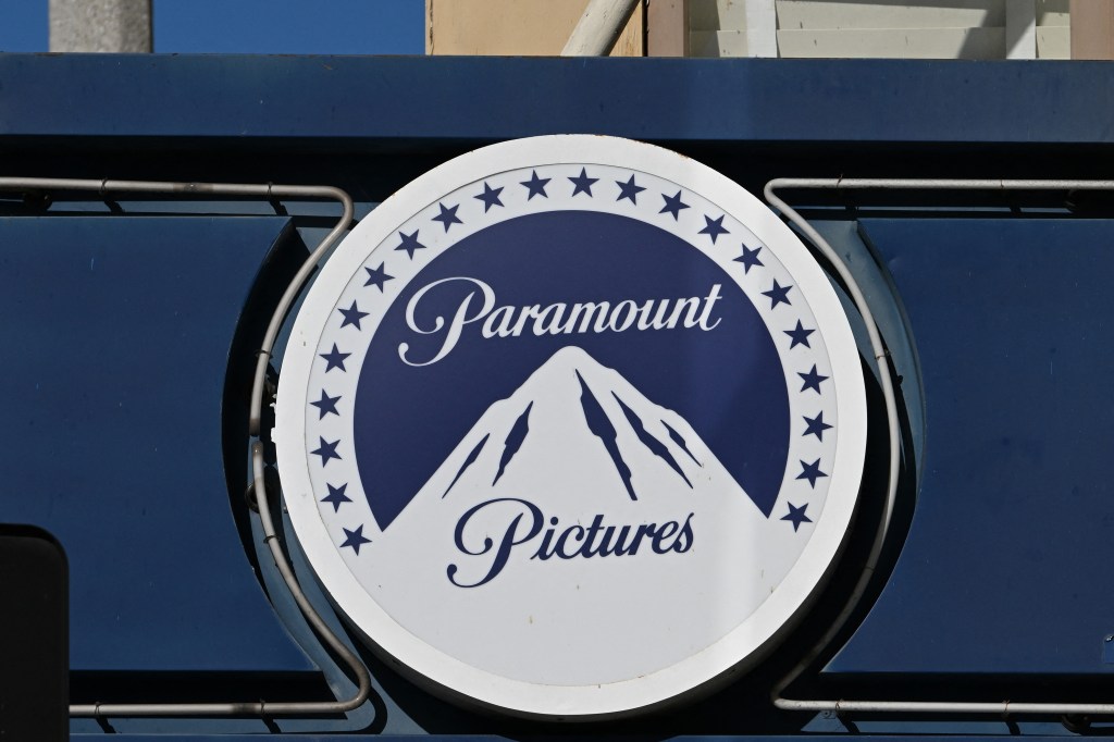 The Paramount logo, a white circle with a blue mountain and stars, mounted on a blue wall.
