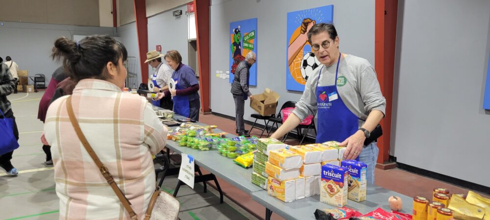 Scott Chanin helps distribute food at a 