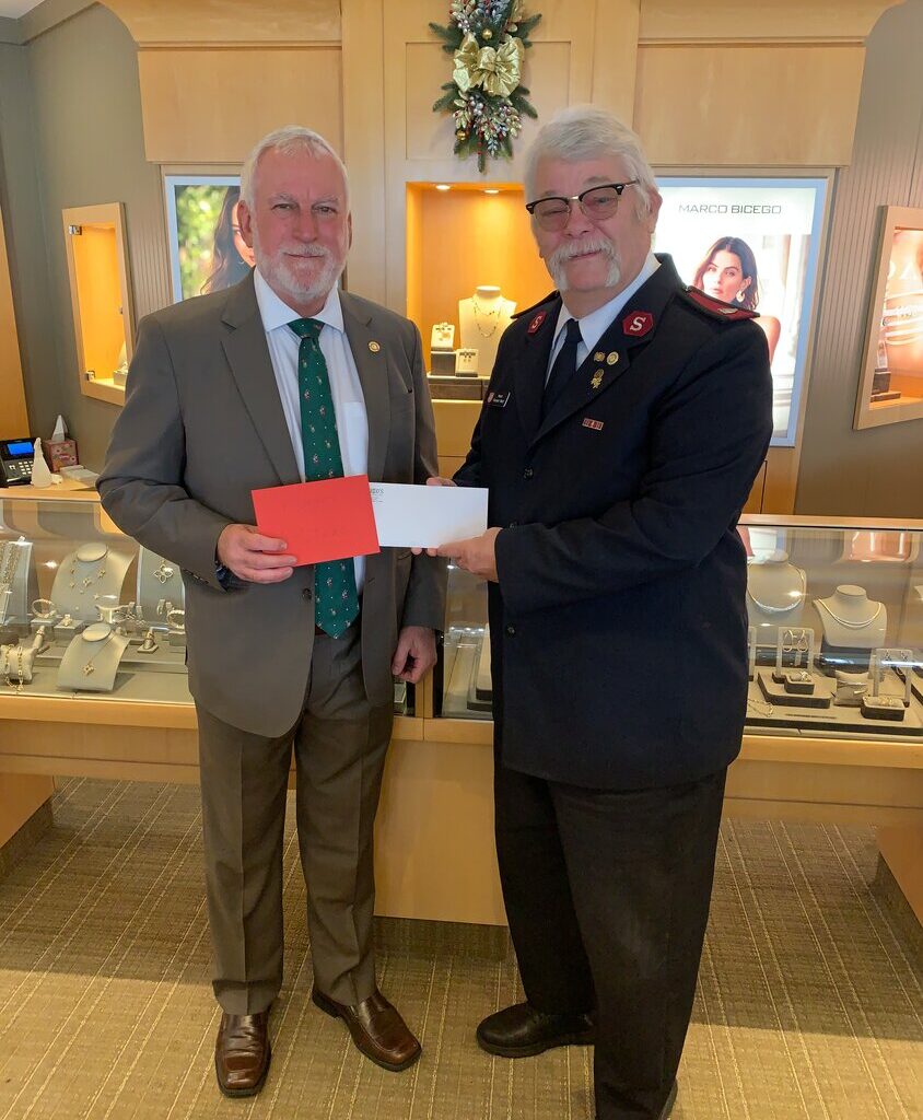 John Rutkowski presents a check for $1,425 to the Salvation Army.
