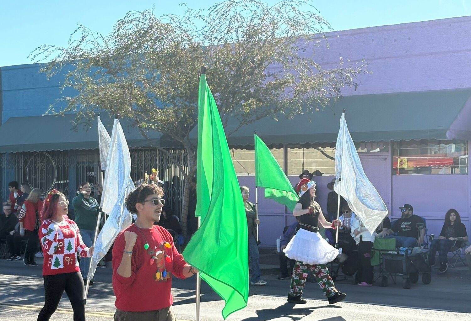 The festively dressed Apollo High School flag line twirls its plags during the Hometown Christmas Parade Dec. 13 in downtown Glendale.