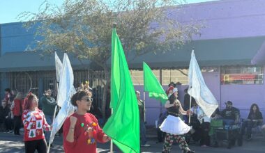 The festively dressed Apollo High School flag line twirls its plags during the Hometown Christmas Parade Dec. 13 in downtown Glendale.